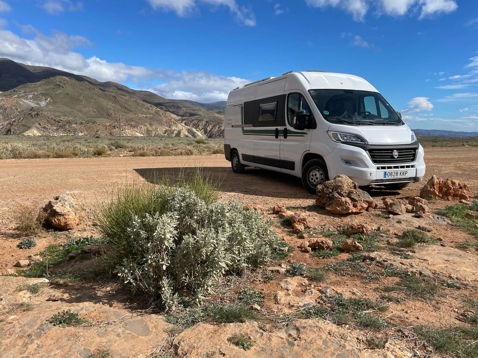 Furgoneta camper Alquicamper aparcada en paisaje desértico de Almería · flota propia de alquiler en Madrid